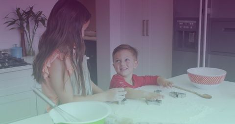 Caucasian Siblings Enjoying Cooking Together in Kitchen
