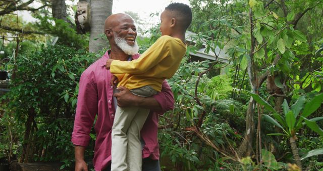 Happy Grandfather Bonding with Grandson in Lush Backyard Garden - Download Free Stock Images Pikwizard.com