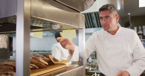 Chef Preparing Sandwiches in Bustling Restaurant Kitchen