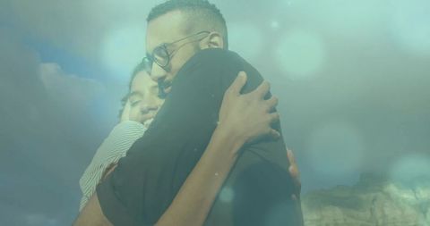 Romantic Couple Embracing Outdoors Under Bright Sky