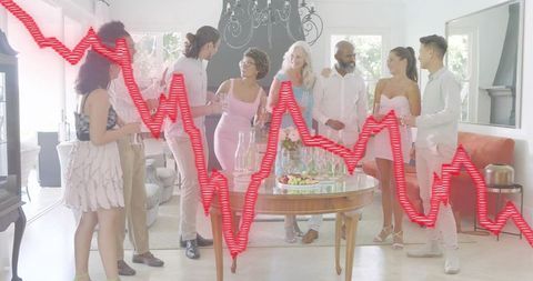 Diverse group chatting and celebrating around dining table with red market trend overlay