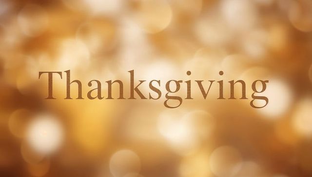 Golden thanksgiving text greeting featuring warm bokeh glow for holiday cards