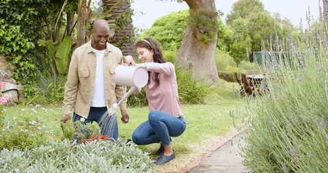 Friends Enjoying Gardening Together in Peaceful Backyard