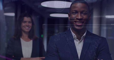 Confident business professionals in futuristic data center corridor