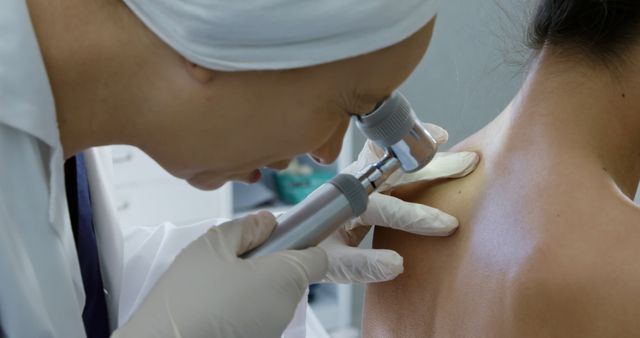 Dermatologist Examining Woman Skin with Dermatoscope in Clinic - Download Free Stock Images Pikwizard.com