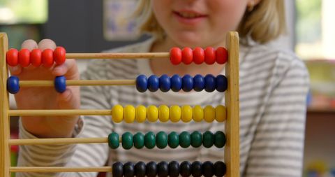 Young Schoolgirl Counting Beads on Abacus in Classroom - Download Free Stock Images Pikwizard.com