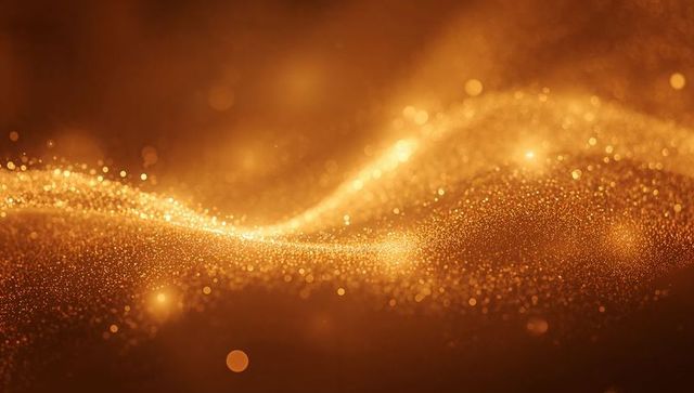Shimmering golden particle waves with bokeh glow for luxury abstract background texture