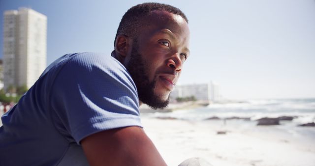 Thoughtful Man Relaxing Outdoors on Sunny Beach Day - Download Free Stock Images Pikwizard.com