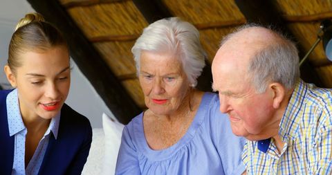 Senior couple engaged with real estate agent indoors