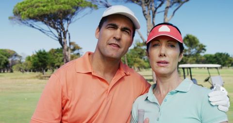 Happy couple enjoying a day golfing on the course