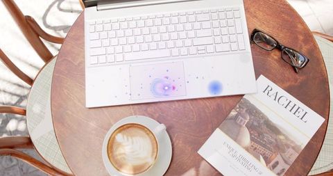 Outdoor Cafe Table with Laptop and Latte in Relaxed City Setting