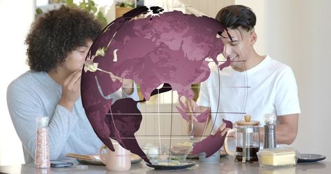 Friends sharing breakfast at kitchen counter with magenta globe overlay, global connection