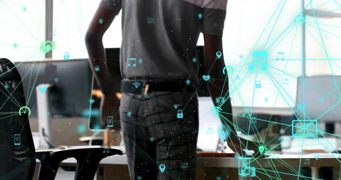 Connected Icons over Man Using Laptop in Office Setting