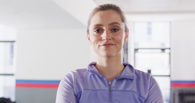 Image portrait caucasian woman smiling to camera at a gym. Exercise, fitness and healthy lifestyle.