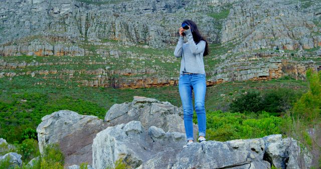 Woman Using Camera to Explore Rocky Landscape - Download Free Stock Images Pikwizard.com