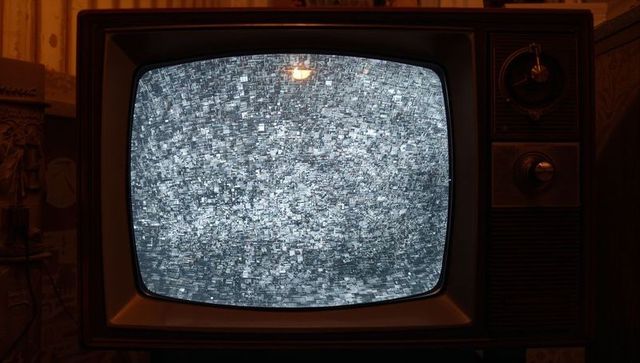 Vintage CRT Television Showing Static on Screen in Retro Wooden Cabinet Living Room