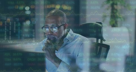 Businessman Analyzing Virtual Data in Modern Office at Night