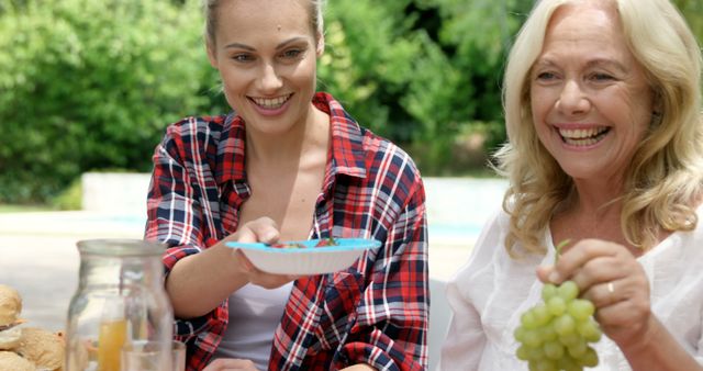 Smiling Women Enjoying Outdoor Lunch with Fresh Fruit - Download Free Stock Images Pikwizard.com