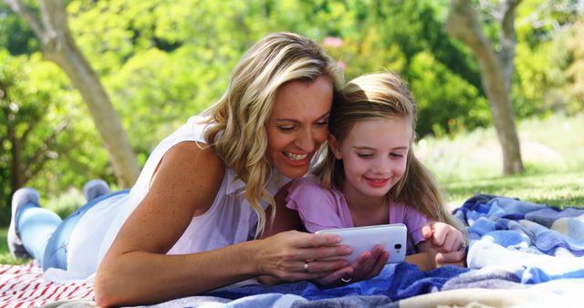 Mother and Daughter Laughing While Using Smartphone Outdoors - Download Free Stock Images Pikwizard.com