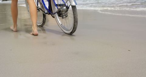 Woman Walking Bicycle on Sandy Beach by Ocean Waves - Download Free Stock Images Pikwizard.com