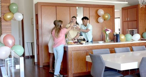 Friends Gathering in Kitchen for Home Party Celebration