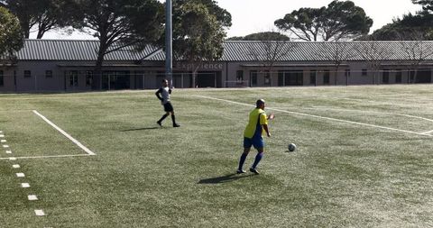 Youth soccer match on sunny day with focus on teamwork