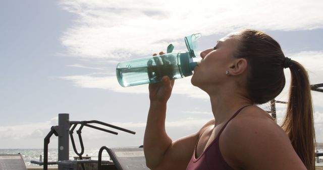 Fit Woman Drinking Water During Outdoor Workout by Seaside - Download Free Stock Images Pikwizard.com