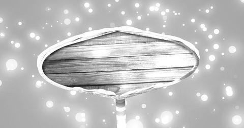 Festive wooden sign with snow and glowing lights