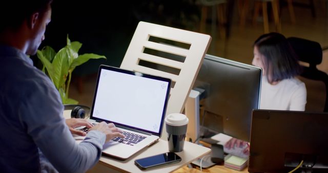 Professionals Working Late in Modern Office with Laptops and Coffee - Download Free Stock Images Pikwizard.com