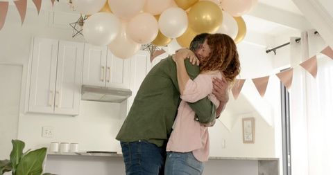 Couple Celebrating Engagement in Decorated Home Kitchen