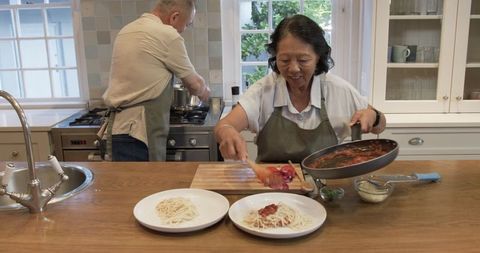 Senior Couple Cooking Together in Kitchen Sharing Joyful Moments