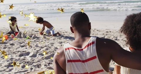 Family Enjoying Beach Outing with Sandcastle Fun