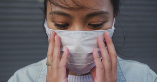 Woman Adjusting Protective Face Mask During Pandemic - Download Free Stock Images Pikwizard.com