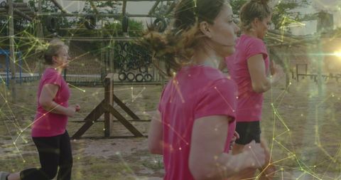 Women running obstacle course with geometric overlay
