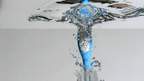 Toothbrush Falling into Water in Super Slow Motion