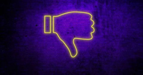 Neon yellow thumbs down symbol against purple brick wall