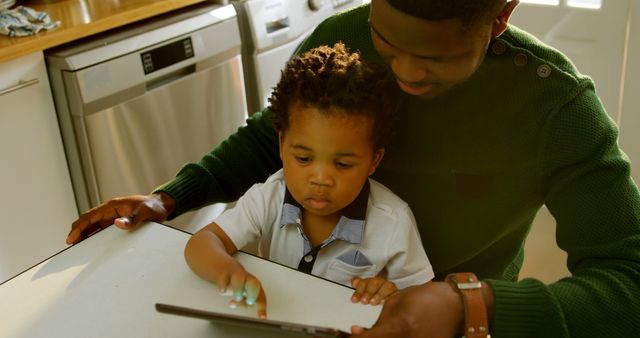 Father and Son Using Digital Tablet in Kitchen - Download Free Stock Images Pikwizard.com