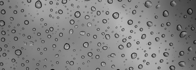 Close-up of rain drops on a glass window positioned against a cloudy sky, evoking a mood of tranquility and reflection. Ideal for backgrounds, nature courses, weather-related projects, environmental awareness materials, and design elements in advertising. Emphasizes the beauty and intricacy of simple natural elements.