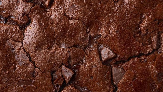 Glistening Fudgy Chocolate Brownie Close-Up with Melted Chunks and Cracked Surface