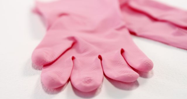 Close-up of pink gloves against white background