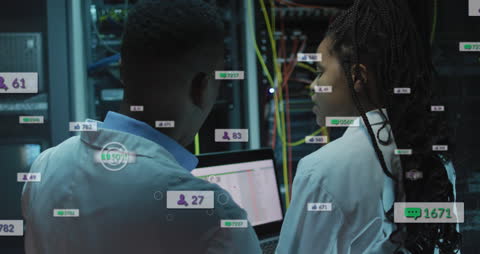 African American Engineers Analyzing Server with Social Media Data Overlay