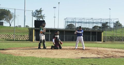Players Engaging in Baseball Game on Sunny Day