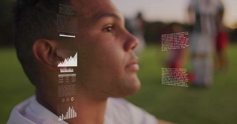 Soccer Player Analyzing Data with Futuristic Tech on Field at Dusk