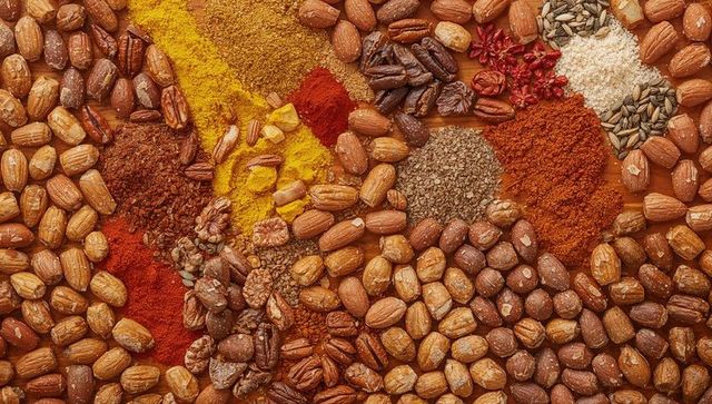 Roasted Nuts and Vibrant Spices Flatlay Forming Warm Textured Food Background