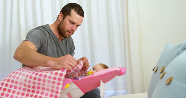 Father Tucking Baby in Cradle with Pink Polka Dot Blanket - Download Free Stock Images Pikwizard.com