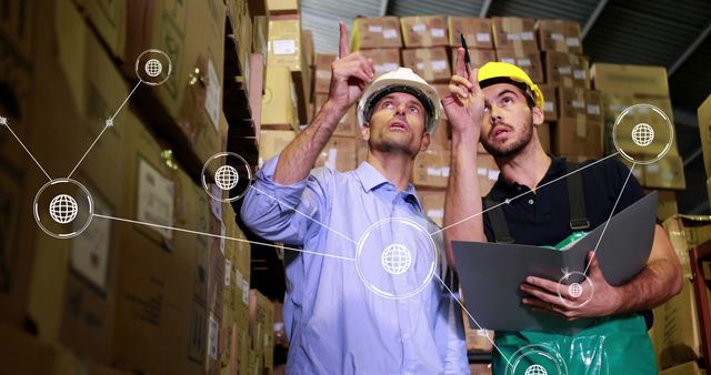 Warehouse workers integrating technology with virtual network planning - Download Free Stock Images Pikwizard.com