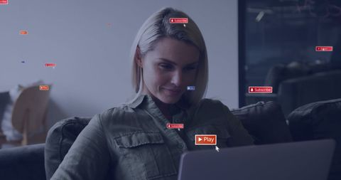 Smiling Woman Engaging with Social Media Notifications on Laptop