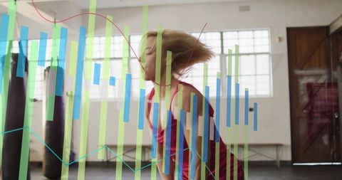 Female Boxer Training in Gym with Fitness Data Overlay Showing Performance Analytics