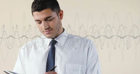 Executive writing notes with waveform overlay for business analytics and planning