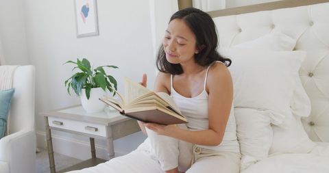 Asian Woman Finding Relaxation Reading Book in Cozy Bedroom - Download Free Stock Images Pikwizard.com